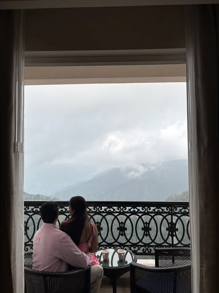 The two of us on the balcony, watching clouds roll over the mountains